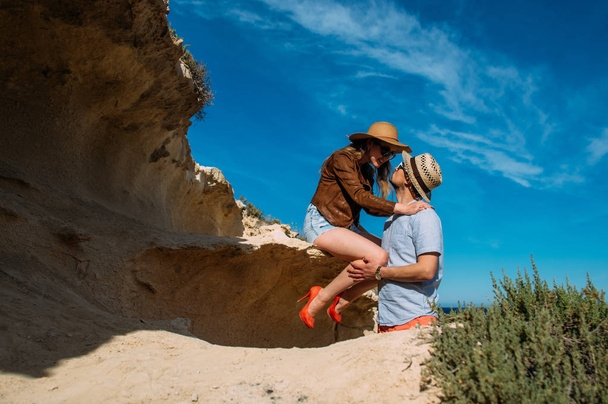Couple in sunglasses embrace in the day in the hills, Malta - Foto, Bild