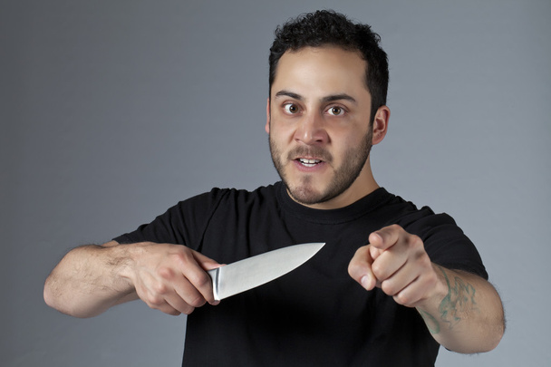 an angry man holding a knife - Photo, Image