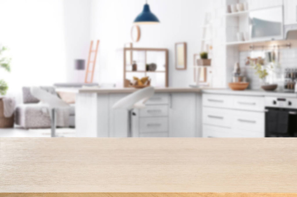 Empty light wooden table in modern kitchen. Mockup for design - Photo, image