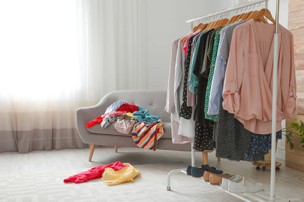 Mess in dressing room with sofa. Renew wardrobe - Zdjęcie, obraz