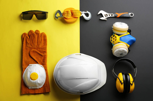 Flat lay composition with safety equipment and space for text on color background - Foto, Imagen