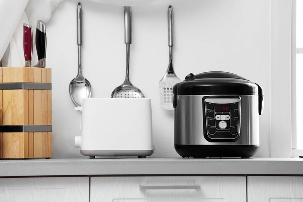 Modern electric multi cooker and toaster on kitchen countertop - Fotografie, Obrázek