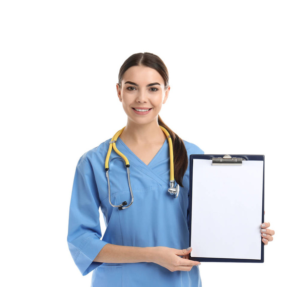 Portrait of medical assistant with stethoscope and clipboard on white background. Space for text - 写真・画像