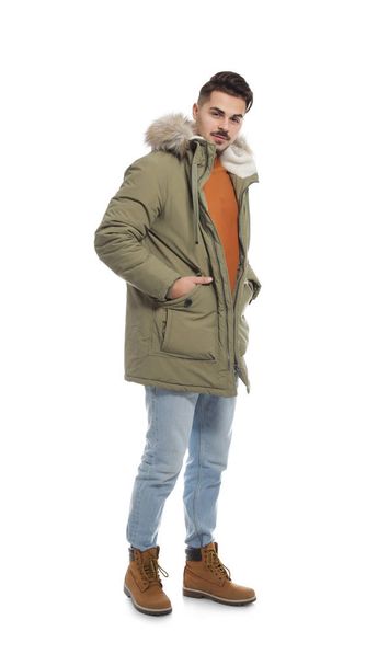 Young man wearing warm clothes on white background. Ready for winter vacation - Foto, afbeelding