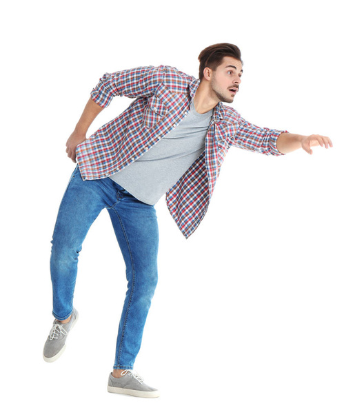 Young man attracted to magnet on white background - Photo, Image