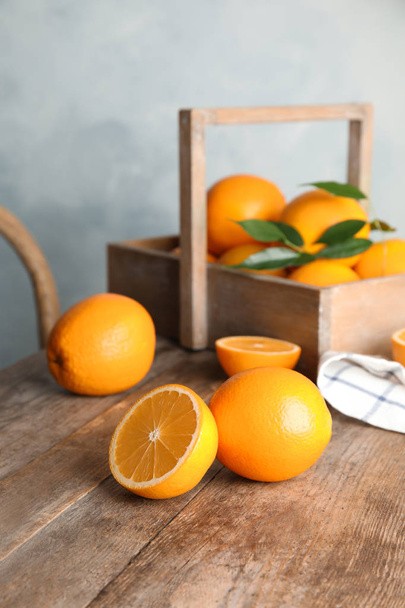 Fresh juicy oranges on wooden table. Healthy fruits - Foto, Bild