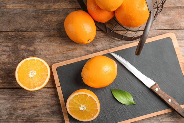 Fresh juicy oranges on wooden table, top view - Photo, image