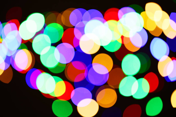 Beautiful colorful lights on dark background. Bokeh effect - Foto, Imagem