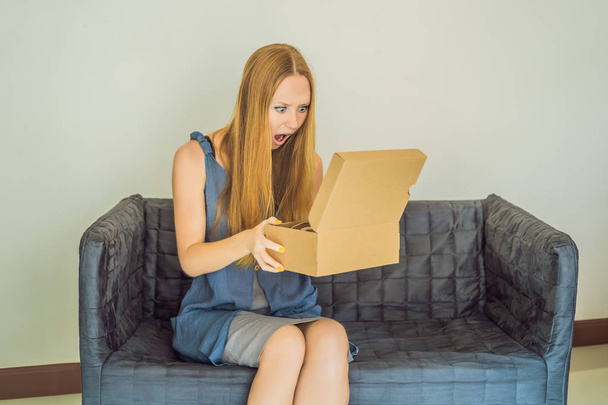 young woman received online shopping parcel opening boxes and buying fashion items by using credit card - Foto, Imagem
