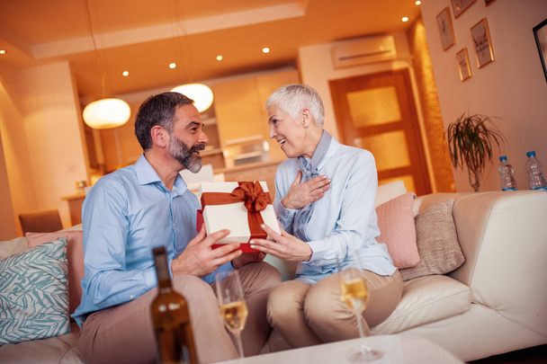 Portrait of loving mature couple celebrating Valentines day at home.  - Photo, Image