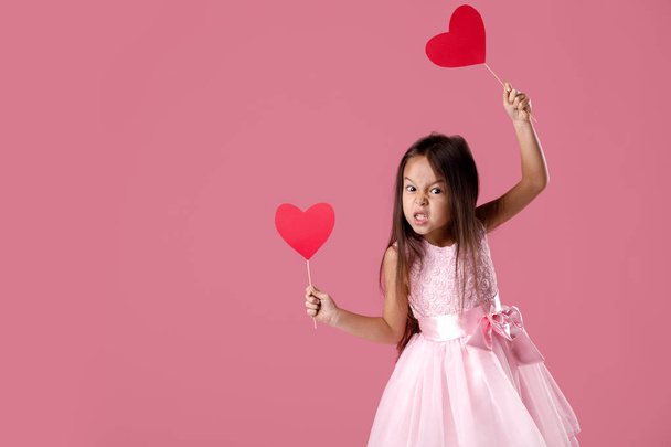 cute little girl in a pink dress holding a paper heart - Фото, изображение