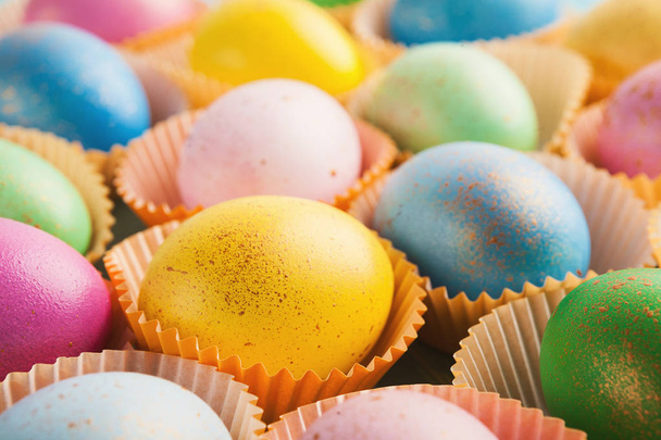 Colorful easter eggs in paper forms for cupcakes - Photo, Image