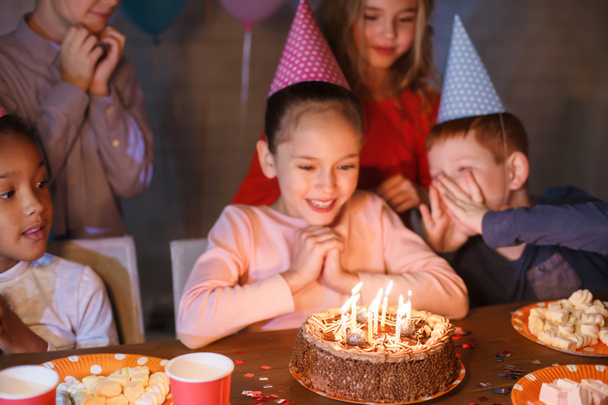 Girl celebrating birthday and making wish at home - Foto, afbeelding