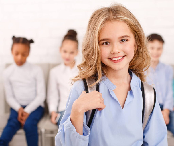 Portrait of school girl with classmates on background - Foto, Imagem