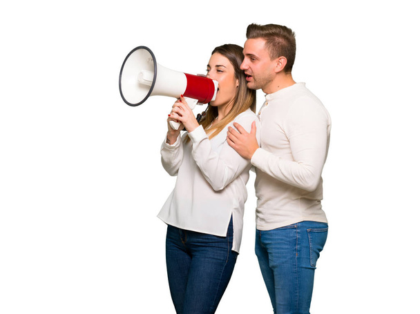 Couple in valentine day shouting through a megaphone - Foto, Imagen