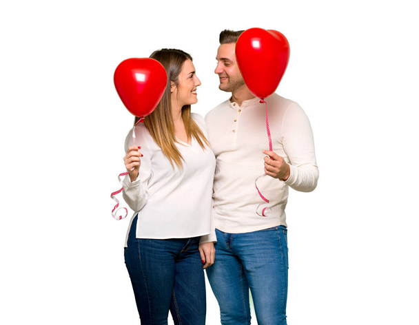 Couple in valentine day with balloons with heart shape - 写真・画像