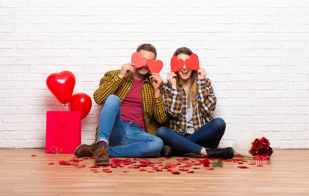 Couple in valentine day at indoors holding a heart symbol - Photo, Image