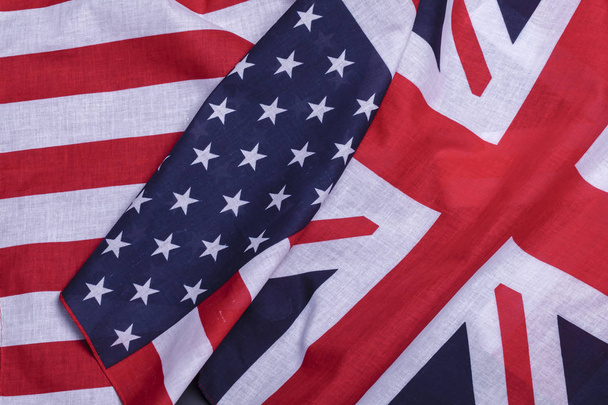Two flags English union jack and USA star spangled banner. Material symbols of first world countries - Foto, imagen