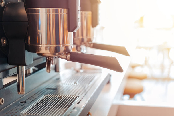 Espresso coffee machine in restaurant with warm sun glow - Фото, зображення