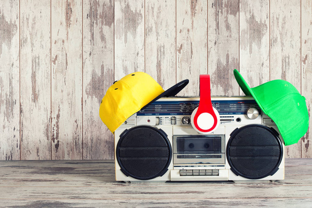 Vintage audio player and fashionable colored caps,headphones,.The concept of the music Hip hop style. - Foto, imagen