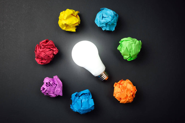 Great idea concept with crumpled colorful paper and light bulb - Photo, Image