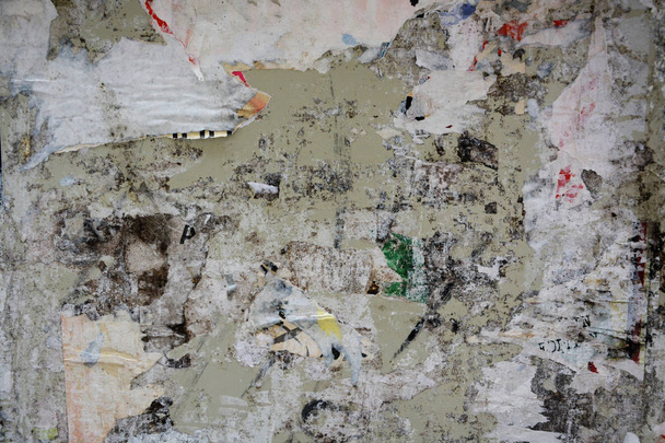 Colorful torn posters on grunge old walls as creative and abstract background with space for text - Fotoğraf, Görsel