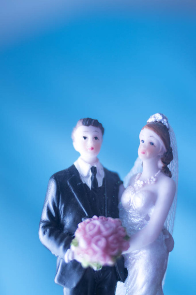 Wedding couple marriage cake topper plastic figures with tuxedo evening suit, white weddding dress veil. - Photo, Image