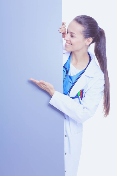 A female doctor with a blank billboard. Woman doctor - Valokuva, kuva