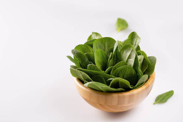 Fresh spinach leaves in wooden bowl. Healthy food with copy space. Detox. Summer time. Selective focus. - Φωτογραφία, εικόνα