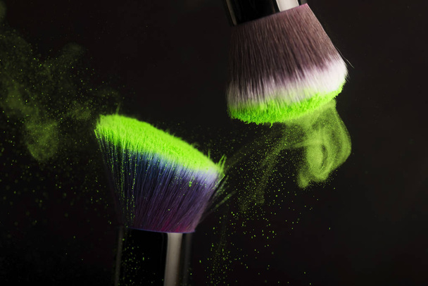 Cosmetics brush and colorful makeup powder - Foto, afbeelding