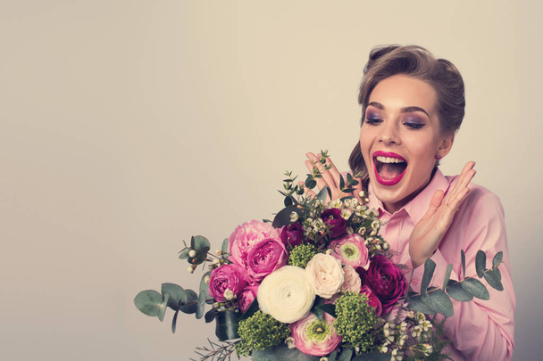 Woman surprised with bunch of flowers, funny emotional expression - Φωτογραφία, εικόνα
