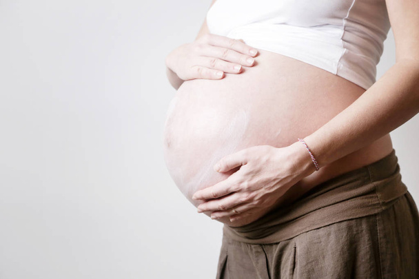 Pregnant woman belly - studio shot - Фото, изображение