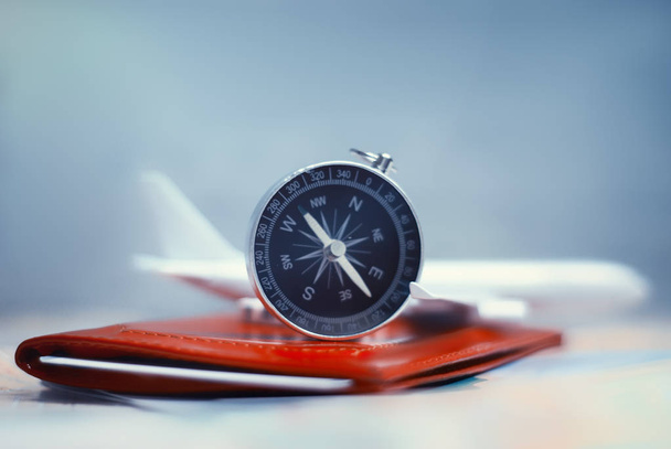 Time to Travel. Idea for tourism with an airplane, passport and tickets, compass and map on a light background. Concept on the theme of flights - Foto, imagen