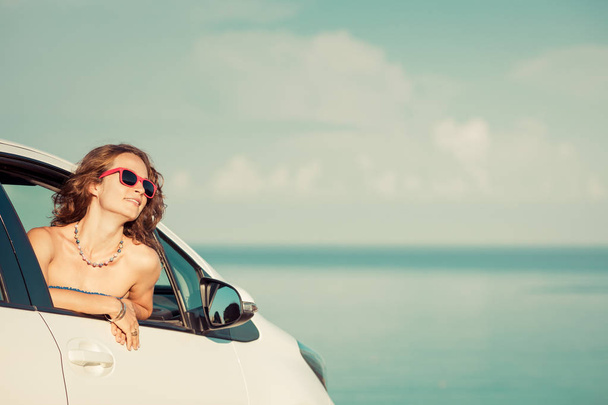 Happy woman travel by car. Person having fun on the beach. Summer vacation concept - Photo, Image