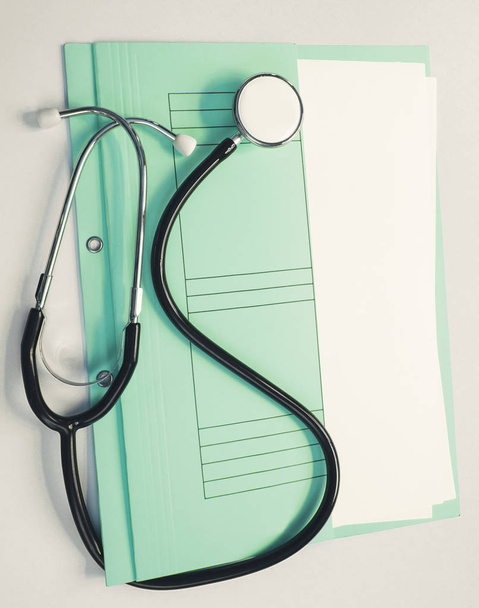 Medical patient file with stethoscope on white background - Foto, Imagem