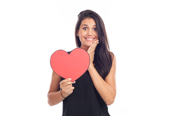 beautiful brunette woman showing big blank red heart on white backdrop, happy valentines day concept - Foto, Imagem