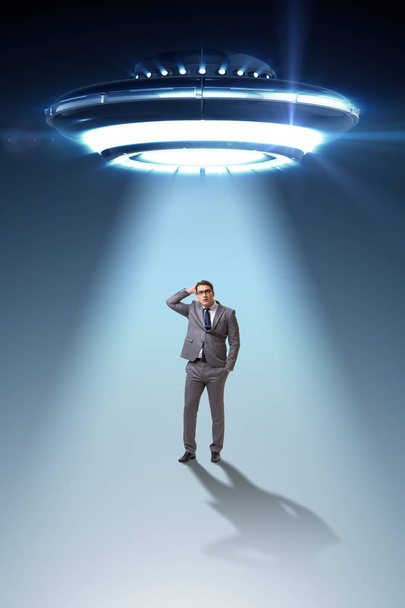 Flying saucer abducting young businessman  - Photo, Image