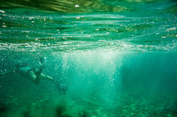 Underwater scene in Ionian sea, Zakynthos, Greece, with girls playing in the water - Photo, Image