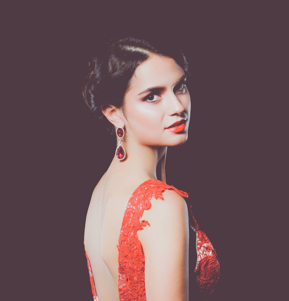 Pretty young model female with dark hair in amazing long red dress - Фото, зображення