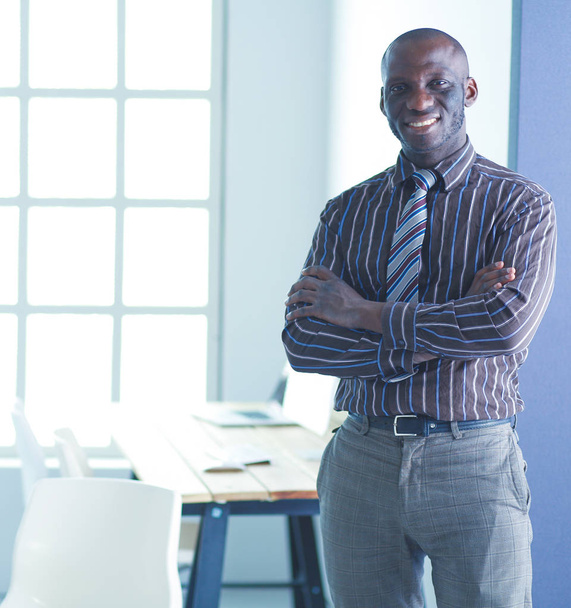 Portrait of an handsome black businessman standing in office - Fotoğraf, Görsel