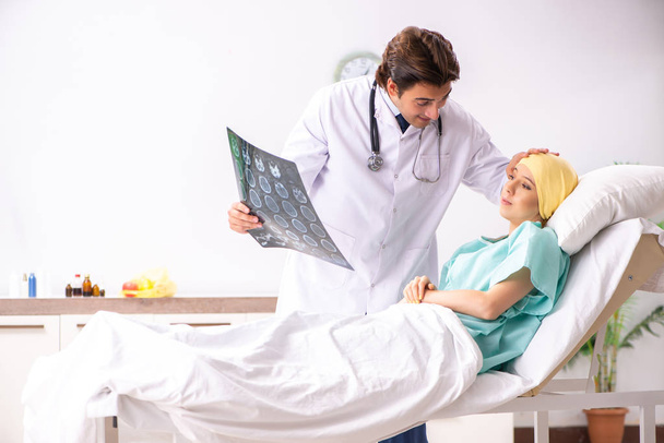 Young handsome doctor visiting female oncology patient  - Photo, Image