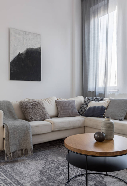 Abstract black and white painting above corner sofa in grey living room - Φωτογραφία, εικόνα