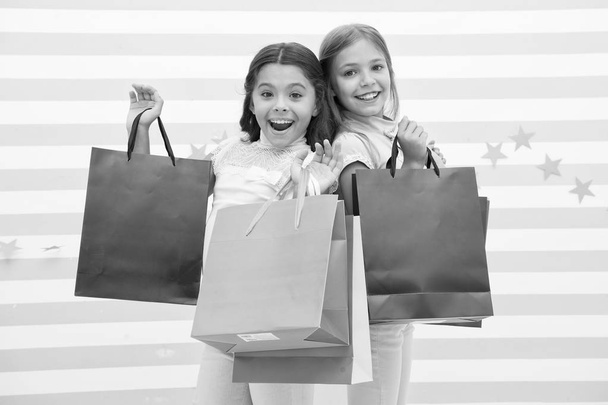 sale. happy little girl bought a lot on big sale. little girls on shopping with happy faces. - Zdjęcie, obraz