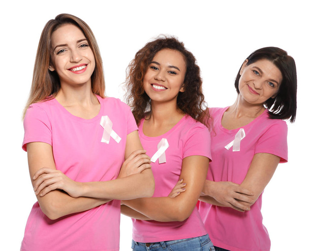 Group of women with silk ribbons on white background. Breast cancer awareness concept - Foto, afbeelding