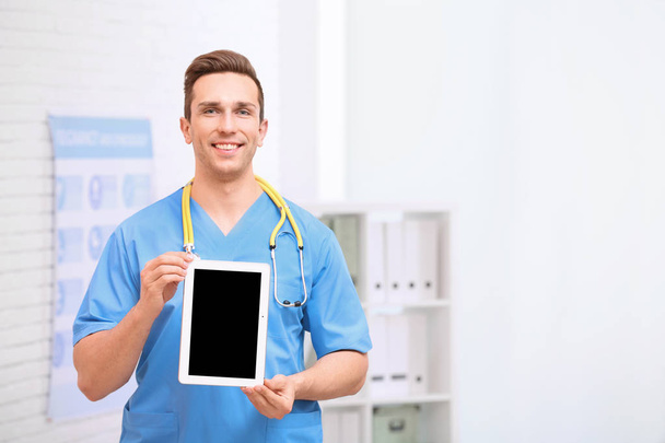 Portrait of medical assistant with stethoscope and tablet in hospital. Space for text - Fotó, kép