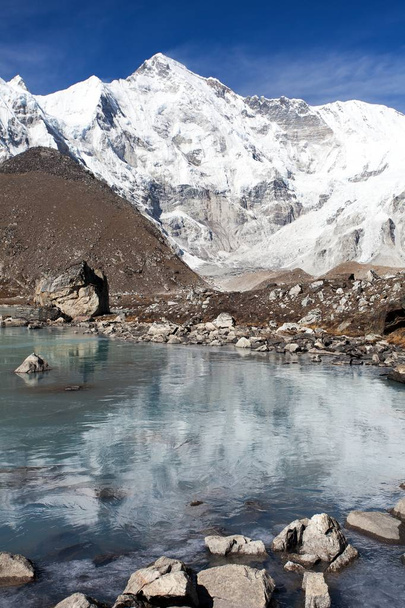 view of mount Cho Oyu mirroring in lake - Cho Oyu base camp - Everest trek - Nepal Himalayas mountains - Valokuva, kuva