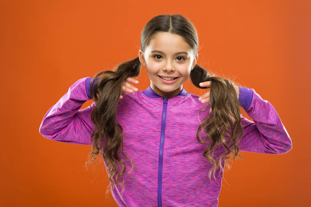 childhood happiness. Family. Kid fashion and sportswear. Happy little girl with long hair. childrens day. Portrait of happy little child. Small girl child. Hairdresser for kids. Little treasure - Foto, imagen