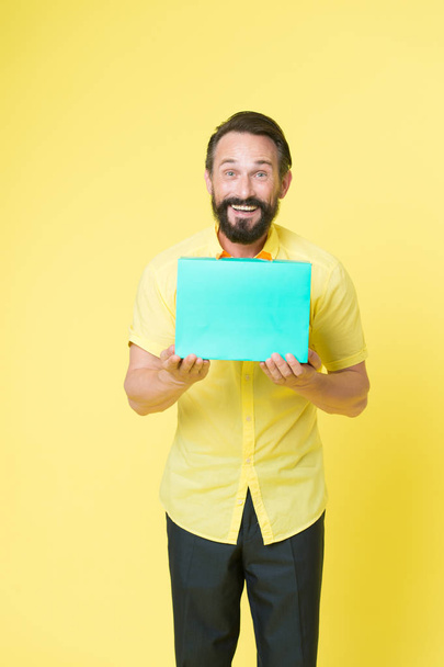 Man emotional enjoying shopping. Bearded mature man with shopping bag on yellow background. Sale and discount. Online shopping. Profitable purchase. Shop assistant or sales expert. Shopping happiness - Fotó, kép