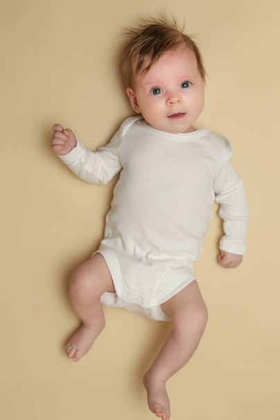 Adorable retrato de recién nacido sobre el fondo amarillo, plano de estudio
 - Foto, imagen
