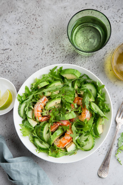 healthy avocado and prawn salad in white  bowl, top view - 写真・画像
